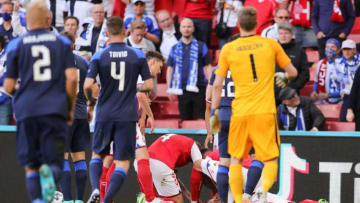 Denmark's players gather around midfielder Christian Eriksen after he collapsed on the pitch during the UEFA EURO 2020 Group B football match between Denmark and Finland at the Parken Stadium in Copenhagen on June 12, 2021. (Photo by Friedemann Vogel / various sources / AFP) (Photo by FRIEDEMANN VOGEL/AFP via Getty Images)