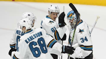 Apr 2, 2016; Nashville, TN, USA; San Jose Sharks goalie James Reimer (34) is congratulated by teammates after a shootout win against the Nashville Predators at Bridgestone Arena. The Sharks won 3-2 in a shootout. Mandatory Credit: Christopher Hanewinckel-USA TODAY Sports