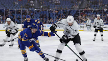 Mar 6, 2022; Buffalo, New York, USA; Los Angeles Kings left wing Alex Iafallo (19) looks to control the puck as Buffalo Sabres defenseman Jacob Bryson (78) defends during the first period at KeyBank Center. Mandatory Credit: Timothy T. Ludwig-USA TODAY Sports