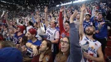 Kansas fans throw up paper as the starting lineup for the Jayhawks are announced before the start of Saturday's game against Indiana.