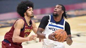 Feb 1, 2021; Cleveland, Ohio, USA; Minnesota Timberwolves center Naz Reid (11) drives against Cleveland Cavaliers center Jarrett Allen (31) in the second quarter at Rocket Mortgage FieldHouse. Mandatory Credit: David Richard-USA TODAY Sports