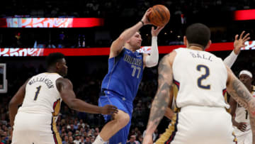 Luka Doncic #77 of the Dallas Mavericks drives to the basket against Zion Williamson #1 of the New Orleans Pelicans (Photo by Tom Pennington/Getty Images)
