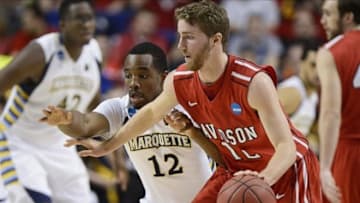 Mar 21, 2013; Lexington , KY, USA; Davidson Wildcats guard Nik Cochran (12) dribbles against Marquette Golden Eagles guard Derrick Wilson (12) in the first half during the second round of the 2013 NCAA tournament at Rupp Arena. Mandatory Credit: Jamie Rhodes-USA TODAY Sports