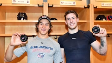 COLUMBUS, OH - OCTOBER 6: Sonny Milano #22 and Pierre-Luc Dubois #18 of the Columbus Blue Jackets hold the pucks from their first career NHL goals scored during a game against the New York Islanders on October 6, 2017 at Nationwide Arena in Columbus, Ohio. Columbus shutout New York 5-0. (Photo by Jamie Sabau/NHLI via Getty Images)