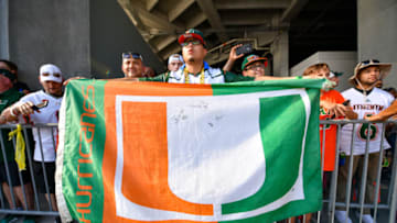ORLANDO, FL - AUGUST 24: A fan of the Miami Hurricanes displays The U flag as the team arrives at the stadium before the game between the Florida Gators and the Miami Hurricanes for the Camping World Kickoff at Camping World Stadium on August 24, 2019 in Orlando, Florida. (Photo by Mark Brown/Getty Images)