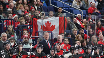 BUFFALO, NY - DECEMBER 26: Fans hold up a Canadian flag behind the bench during the third period against Finland at KeyBank Center on December 26, 2017 in Buffalo, New York. Canada beat Finland 4-2. (Photo by Kevin Hoffman/Getty Images)