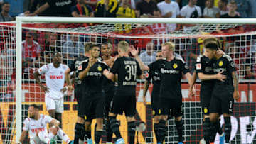 Dortmund's players celebrate after Spanish forward Paco Alcacer scoried the 1-3 goal during the German first division Bundesliga football match 1 FC Cologne v BVB Borussia Dortmund in Cologne, western Germany on August 23, 2019. (Photo by UWE KRAFT / AFP) / RESTRICTIONS: DFL REGULATIONS PROHIBIT ANY USE OF PHOTOGRAPHS AS IMAGE SEQUENCES AND/OR QUASI-VIDEO (Photo credit should read UWE KRAFT/AFP/Getty Images)