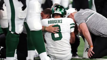 EAST RUTHERFORD, NEW JERSEY - SEPTEMBER 11: Quarterback Aaron Rodgers #8 of the New York Jets is attended to after being sacked by Leonard Floyd #56 of the Buffalo Bills and suffering an apparent Achilles injury in the game at MetLife Stadium on September 11, 2023 in East Rutherford, New Jersey. (Photo by Al Pereira/Getty Images)