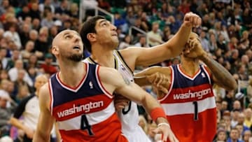 Jan 25, 2014; Salt Lake City, UT, USA; Washington Wizards center Marcin Gortat (4) and Washington Wizards small forward Trevor Ariza (1) try and block out Utah Jazz center Enes Kanter (0) during the fourth quarter at EnergySolutions Arena. Utah Jazz won the game 104-101. Mandatory Credit: Chris Nicoll-USA TODAY Sports