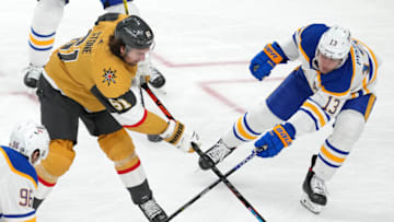 Feb 1, 2022; Las Vegas, Nevada, USA; Vegas Golden Knights right wing Mark Stone (61) shoots the puck under the stick of Buffalo Sabres defenseman Mark Pysyk (13) during the third period at T-Mobile Arena. Mandatory Credit: Stephen R. Sylvanie-USA TODAY Sports