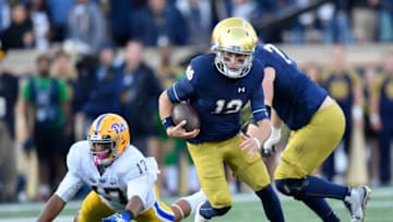 SOUTH BEND, IN - OCTOBER 13: Ian Book #12 of the Notre Dame Fighting Irish scramble to avoid the tackle from Rashad Weaver #17 of the Pittsburgh Panthers in the second half at Notre Dame Stadium on October 13, 2018 in South Bend, Indiana. (Photo by Quinn Harris/Getty Images)