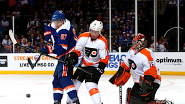 UNIONDALE, NEW YORK - OCTOBER 27: Anders Lee #27 of the New York Islanders and Matt Niskanen #15 of the Philadelphia Flyers battle for the puck in front of Carter Hart #79 during the first period at NYCB Live's Nassau Coliseum on October 27, 2019 in Uniondale, New York. (Photo by Mike Stobe/NHLI via Getty Images)