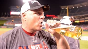 Sep 17, 2014; Anaheim, CA, USA; Los Angeles Angels manager Mike Scioscia celebrates after winning the American League West Division title against the Seattle Mariners at Angel Stadium of Anaheim. Mandatory Credit: Kirby Lee-USA TODAY Sports