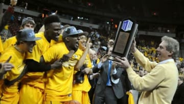 Mar 14, 2015; Las Vegas, NV, USA; Wyoming Cowboys head coach Larry Shyatt holds the Mountain West Tournament trophy near his players after defeating San Diego State 45-43 for the title at Thomas and Mack Center. Mandatory Credit: Stephen R. Sylvanie-USA TODAY Sports