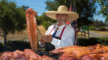 SOLVANG, CA - JULY 4: "Barbecue Billy" cooks Santa Maria-style tri-tip and ribs outside in the 90-degree heat on July 4, 2020, in Solvang, California. Despite the on-going pandemic and lack of a parade and fireworks, thousands of tourists, primarily from Southern California and Los Angeles flood into this Danish-themed community for a relatively quiet 4th of July holiday weekend. (Photo by George Rose/Getty Images)