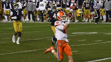 Dec 19, 2020; Charlotte, NC, USA; Clemson quarterback Trevor Lawrence (16) runs 34-yards for a touchdown against Notre Dame during the third quarter of the ACC Championship game at Bank of America Stadium. Mandatory Credit: Ken Ruinard-USA TODAY Sports