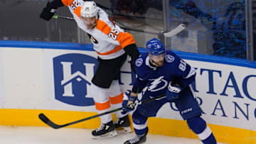 Aug 8, 2020; Toronto, Ontario, CAN; Philadelphia Flyers forward James van Riemsdyk (25) avoids a check from Tampa Bay Lightning defenseman Erik Cernak (81) during the third period of the Eastern Conference qualifications at Scotiabank Arena. Philadelphia defeated Tampa Bay. Mandatory Credit: John E. Sokolowski-USA TODAY Sports
