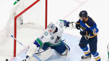 EDMONTON, ALBERTA - AUGUST 19: Jacob Markstrom #25 of the Vancouver Canucks makes a third period save as Brayden Schenn #10 of the St. Louis Blues looks for the rebound in Game Five of the Western Conference First Round during the 2020 NHL Stanley Cup Playoffs at Rogers Place on August 19, 2020 in Edmonton, Alberta, Canada. (Photo by Jeff Vinnick/Getty Images)