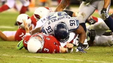 Oct 17, 2013; Phoenix, AZ, USA; Seattle Seahawks linebacker O'Brien Schofield (93) tackles Arizona Cardinals quarterback Carson Palmer (3) at University of Phoenix Stadium. Mandatory Credit: Mark J. Rebilas-USA TODAY Sports