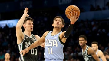 CHARLOTTE, NORTH CAROLINA - FEBRUARY 15: Trae Young #11 of the U.S. Team drives to the basket against Rodions Kurucs #00 of the World Team during the 2019 Mtn Dew ICE Rising Stars at Spectrum Center on February 15, 2019 in Charlotte, North Carolina. (Photo by Streeter Lecka/Getty Images)
