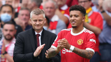 Manchester United's English striker Jadon Sancho (R), with Manchester United's Norwegian manager Ole Gunnar Solskjaer, comes onto the field during the English Premier League football match between Manchester United and Leeds United at Old Trafford in Manchester, north west England, on August 14, 2021. - RESTRICTED TO EDITORIAL USE. No use with unauthorized audio, video, data, fixture lists, club/league logos or 'live' services. Online in-match use limited to 120 images. An additional 40 images may be used in extra time. No video emulation. Social media in-match use limited to 120 images. An additional 40 images may be used in extra time. No use in betting publications, games or single club/league/player publications. (Photo by Adrian DENNIS / AFP) / RESTRICTED TO EDITORIAL USE. No use with unauthorized audio, video, data, fixture lists, club/league logos or 'live' services. Online in-match use limited to 120 images. An additional 40 images may be used in extra time. No video emulation. Social media in-match use limited to 120 images. An additional 40 images may be used in extra time. No use in betting publications, games or single club/league/player publications. / RESTRICTED TO EDITORIAL USE. No use with unauthorized audio, video, data, fixture lists, club/league logos or 'live' services. Online in-match use limited to 120 images. An additional 40 images may be used in extra time. No video emulation. Social media in-match use limited to 120 images. An additional 40 images may be used in extra time. No use in betting publications, games or single club/league/player publications. (Photo by ADRIAN DENNIS/AFP via Getty Images)