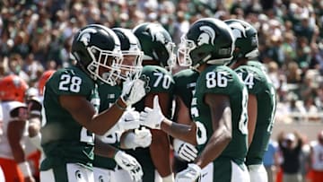 EAST LANSING, MI - SEPTEMBER 02: Madre London #28 of the Michigan State Spartans celebrates a first half touchdown with Trishton Jackson #86 while playing the Bowling Green Falcons at Spartan Stadium on September 2, 2017 in East Lansing, Michigan. (Photo by Gregory Shamus/Getty Images)