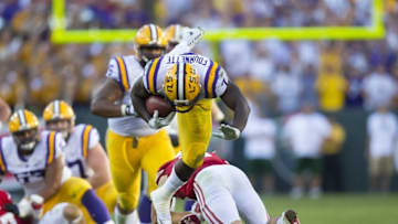 Sep 3, 2016; Green Bay, WI, USA; LSU Tigers running back Leonard Fournette (7) is upended by Wisconsin Badgers safety Leo Musso (19) during the fourth quarter at Lambeau Field. Mandatory Credit: Jeff Hanisch-USA TODAY Sports