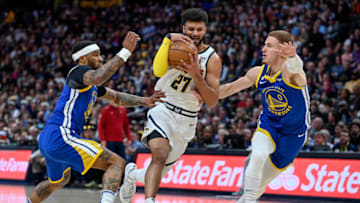 DENVER, CO - APRIL 2: Jamal Murray #27 of the Denver Nuggets drives to the rim against the Golden State Warriors in the first half of a game at Ball Arena on April 2, 2023 in Denver, Colorado. NOTE TO USER: User expressly acknowledges and agrees that, by downloading and or using this photograph, User is consenting to the terms and conditions of the Getty Images License Agreement. (Photo by Dustin Bradford/Getty Images)