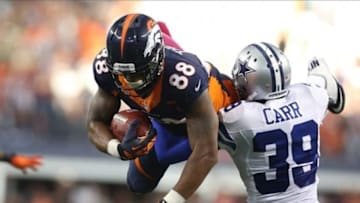 Oct 6, 2013; Arlington, TX, USA; Denver Broncos receiver Demaryius Thomas (88) makes a leaping catch late in the fourth quarter against Dallas Cowboys cornerback Brandon Carr (39) at AT