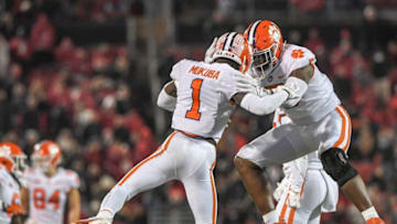 Clemson safety Andrew Mukuba (1) is congratulated by defensive end K.J. Henry (5) after stopping Louisville quarterback Malik Cunningham (3) during the fourth quarter at Cardinal Stadium in Louisville, Kentucky Saturday, November 6, 2021.Ncaa Football Clemson At Louisville