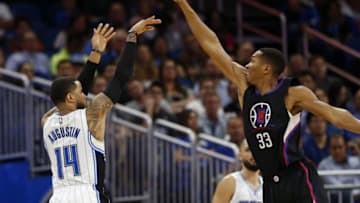 Dec 14, 2016; Orlando, FL, USA; LA Clippers forward Wesley Johnson (33) blocks Orlando Magic guard D.J. Augustin (14) shot during the second quarter at Amway Center. Mandatory Credit: Kim Klement-USA TODAY Sports