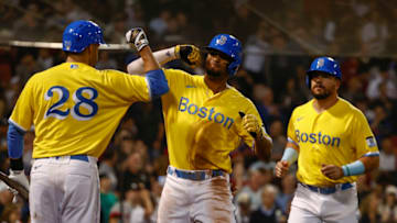 J.D. Martinez #28 of the Boston Red Sox congratulates Xander Bogaerts #2 (Photo By Winslow Townson/Getty Images)