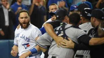 Sep 26, 2016; Toronto, Ontario, CAN; Toronto Blue Jays catcher Russell Martin (55) shouts as New York Yankees players and coaches restrain catcher Gary Sanchez (24) after a bench clearing brawl broke out in the third inning at Rogers Centre. Mandatory Credit: Dan Hamilton-USA TODAY Sports