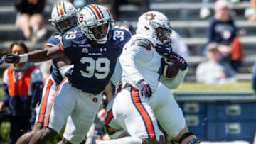 Auburn football edge Dylan Brooks (39) tackles Auburn Tigers running back Sean Jackson (44) during the A-Day spring practice at Jordan-Hare Stadium in Auburn, Ala., on Saturday, April 9, 2022.
