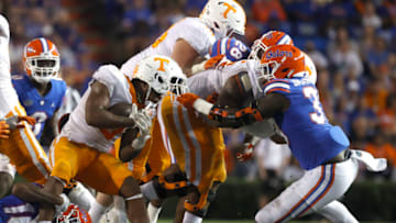 Sep 25, 2021; Gainesville, Florida, USA; Tennessee Volunteers running back Tiyon Evans (8) runs with the ball as Florida Gators defensive lineman Princely Umanmielen (33) tackles with he face mask during the fourth quarter at Ben Hill Griffin Stadium. Mandatory Credit: Kim Klement-USA TODAY Sports