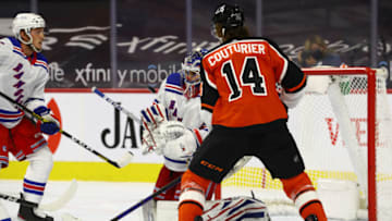 Mar 27, 2021; Philadelphia, Pennsylvania, USA; Philadelphia Flyers center Sean Couturier (14) watches as New York Rangers goalie Igor Shesterkin (31) reaches for a loose puck in the second period at Wells Fargo Center. Mandatory Credit: Kyle Ross-USA TODAY Sports