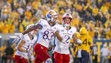 Sep 10, 2022; Morgantown, West Virginia, USA; Kansas Jayhawks wide receiver Quentin Skinner (83) catches a touchdown pass and celebrates with teammates during overtime against the West Virginia Mountaineers at Mountaineer Field at Milan Puskar Stadium. Mandatory Credit: Ben Queen-USA TODAY Sports