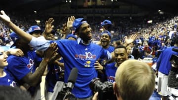 Mar 5, 2014; Lawrence, KS, USA; Kansas Jayhawks center Joel Embiid (center) celebrates after the game against the Texas Tech Red Raiders at Allen Fieldhouse. Kansas won the game 82-57. Mandatory Credit: John Rieger-USA TODAY Sports1