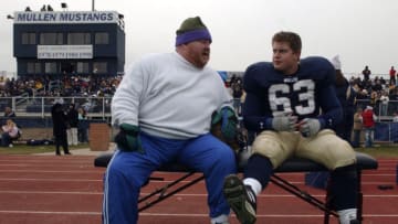 DENVER,CO--NOVEMBER 27TH 2004--Leon White, Jesse White's father, , talks with Jesse on the bench after he was injured against Ft. Collins during the 5A semi-final game at Mullen Saturday afternoon. (PLEASE DO NOT CROP OUT PRESS BOX, THANKS AC) THE DENVER POST/ ANDY CROSS (Photo By Andy Cross/The Denver Post via Getty Images)