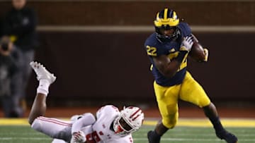 ANN ARBOR, MI - OCTOBER 13: Karan Higdon #22 of the Michigan Wolverines escapes the table of Rachad Wildgoose #5 of the Wisconsin Badgers during a second half run on October 13, 2018 at Michigan Stadium in Ann Arbor, Michigan. Michigan won the game 38-13. (Photo by Gregory Shamus/Getty Images)