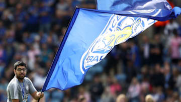 A member of Leicester City staff waves a flag (Photo by Tim Goode/PA Images via Getty Images)