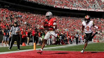 Ohio State Buckeyes wide receiver Garrett Wilson (5) scores a touchdown with Maryland Terrapins linebacker Terrence Lewis (0) trailing during the second half of Saturday's NCAA Division I football game at Ohio Stadium in Columbus on October 9, 2021.Osu21mary Bjp 1422