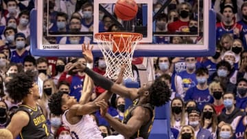 LAWRENCE, KS - FEBRUARY 05: Jonathan Tchamwa Tchatchoua #23 of the Baylor Bears knocks the ball away from Ochai Agbaji #30 of the Kansas Jayhawks in the second half at Allen Fieldhouse on February 5, 2022 in Lawrence, Kansas. (Photo by Kyle Rivas/Getty Images)