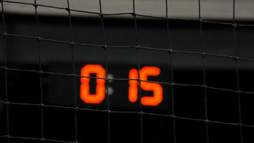 Feb 14, 2023; Scottsdale, AZ, USA; New clocks are installed in behind home plate and in the outfield during demonstrations of rules changes for the 2023 MLB season and how they will be implemented for spring training and the regular season at Salt River Fields at Talking Stick. Mandatory Credit: Rob Schumacher-USA TODAY Sports