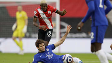 Southampton's Malian midfielder Moussa Djenepo (L) vies with Chelsea's Spanish defender Marcos Alonso during the English Premier League football match between Southampton and Chelsea at St Mary's Stadium in Southampton, southern England on February 20, 2021. (Photo by Kirsty Wigglesworth / POOL / AFP) / RESTRICTED TO EDITORIAL USE. No use with unauthorized audio, video, data, fixture lists, club/league logos or 'live' services. Online in-match use limited to 120 images. An additional 40 images may be used in extra time. No video emulation. Social media in-match use limited to 120 images. An additional 40 images may be used in extra time. No use in betting publications, games or single club/league/player publications. / (Photo by KIRSTY WIGGLESWORTH/POOL/AFP via Getty Images)