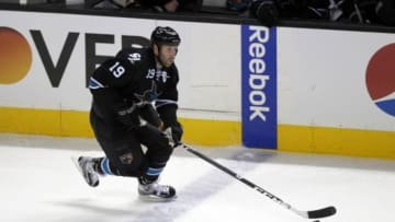 Apr 26, 2014; San Jose, CA, USA; San Jose Sharks center Joe Thornton (19) controls the puck against the Los Angeles Kings during the first period in game five of the first round of the 2014 Stanley Cup Playoffs at SAP Center at San Jose. Mandatory Credit: Cary Edmondson-USA TODAY Sports