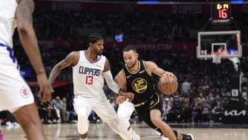 LOS ANGELES, CA - NOVEMBER 28: Stephen Curry #30 of the Golden State Warriors drives against Paul George #13 of the Los Angeles Clippers during the second half at Staples Center on November 28, 2021 in Los Angeles, California. NOTE TO USER: User expressly acknowledges and agrees that, by downloading and/or using this Photograph, user is consenting to the terms and conditions of the Getty Images License Agreement. (Photo by Kevork Djansezian/Getty Images)