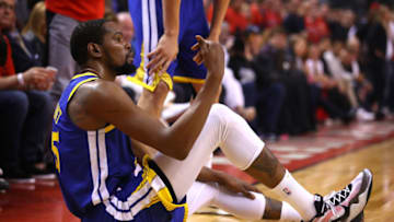 TORONTO, ONTARIO - JUNE 10: Kevin Durant #35 of the Golden State Warriors reacts after sustaining an injury during the second quarter against the Toronto Raptors during Game Five of the 2019 NBA Finals at Scotiabank Arena on June 10, 2019 in Toronto, Canada. NOTE TO USER: User expressly acknowledges and agrees that, by downloading and or using this photograph, User is consenting to the terms and conditions of the Getty Images License Agreement. (Photo by Gregory Shamus/Getty Images)