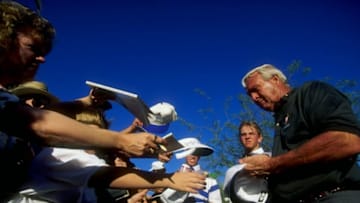 20 Jan 1996: Golfer Arnold Palmer autographs a hat for a young fan during the Bob Hope Chrysler Classic in Palm Desert, California. Mandatory Credit: J.D. Cuban /Allsport