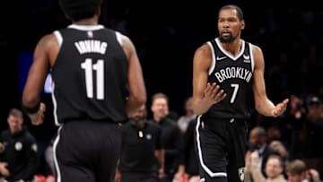 Mar 29, 2022; Brooklyn, New York, USA; Brooklyn Nets forward Kevin Durant (7) reacts to guard Kyrie Irving (11) during the third quarter against the Detroit Pistons at Barclays Center. The Nets defeated the Pistons 130-123. Mandatory Credit: Brad Penner-USA TODAY Sports